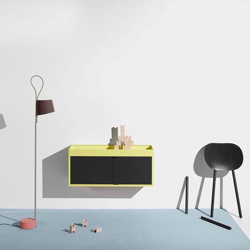 Woodmart theme demo photo of a minimal interior with a chair and cabinet